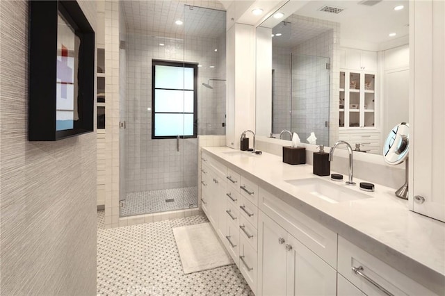 bathroom with a shower with door and vanity