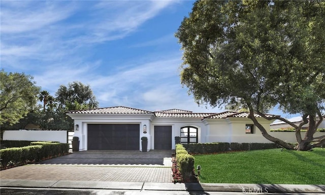 view of front of property with a garage and a front lawn