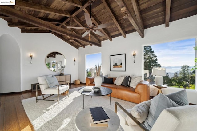 living room featuring ceiling fan, hardwood / wood-style floors, wooden ceiling, and vaulted ceiling with beams