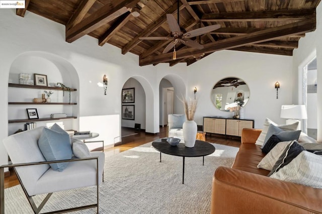 living room featuring ceiling fan, wooden ceiling, hardwood / wood-style floors, and vaulted ceiling with beams