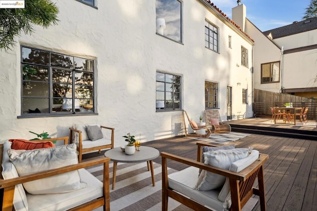 wooden terrace featuring an outdoor hangout area