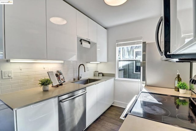 kitchen with sink, dark hardwood / wood-style flooring, white cabinets, and appliances with stainless steel finishes