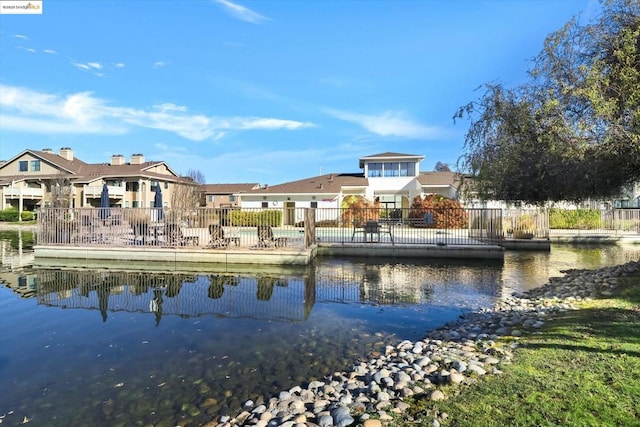 rear view of house featuring a water view