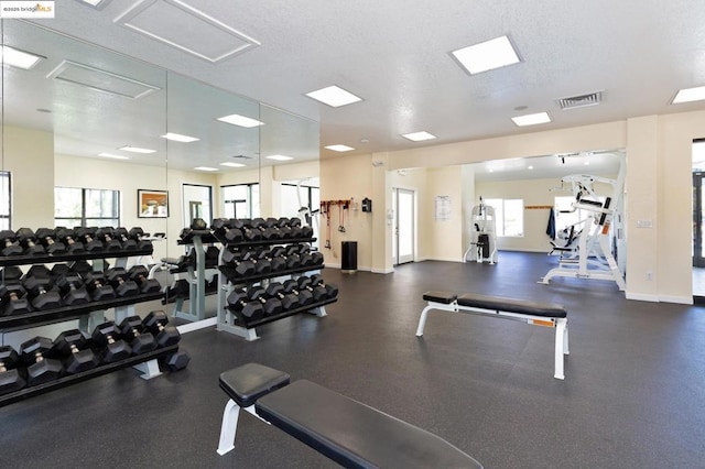 exercise room featuring a textured ceiling