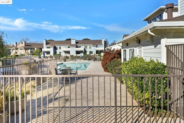 exterior space with a community pool and a patio