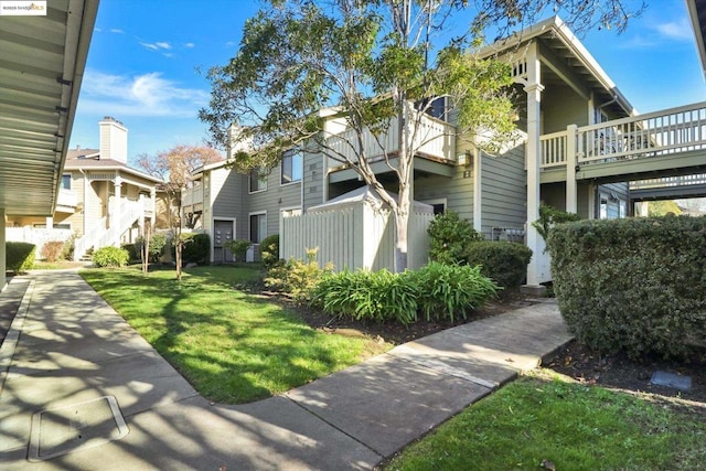 view of side of home with a lawn