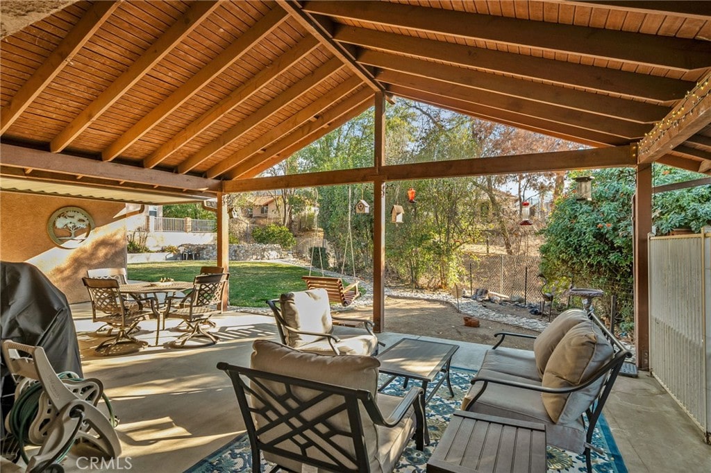 sunroom / solarium featuring wooden ceiling and vaulted ceiling with beams