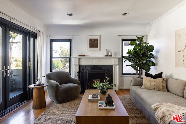 living room with ornamental molding and hardwood / wood-style floors