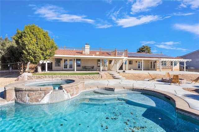 view of swimming pool with a patio and an in ground hot tub