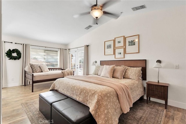 bedroom featuring lofted ceiling, french doors, ceiling fan, and light hardwood / wood-style floors