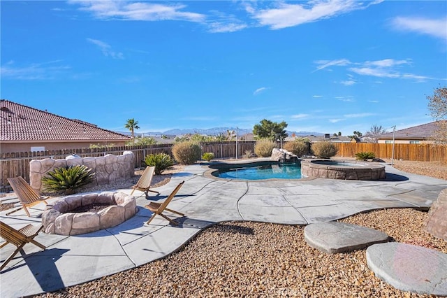 view of swimming pool with a fire pit, an in ground hot tub, and a patio area