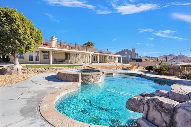 view of swimming pool featuring a patio area and an in ground hot tub