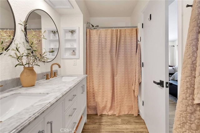 bathroom with a shower with curtain, vanity, and hardwood / wood-style flooring