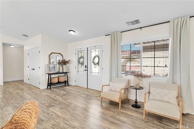 foyer featuring french doors and light hardwood / wood-style flooring