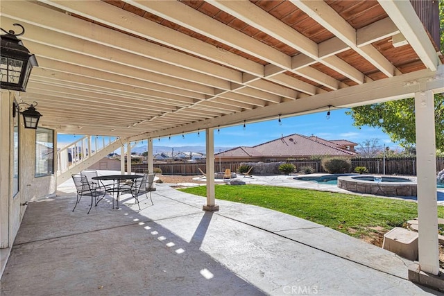 view of patio / terrace featuring a swimming pool with hot tub