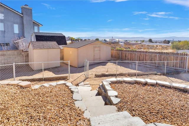 view of yard with a storage unit and a mountain view