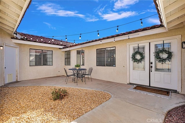 property entrance featuring a patio area