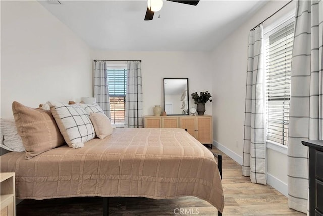 bedroom with ceiling fan and light hardwood / wood-style flooring