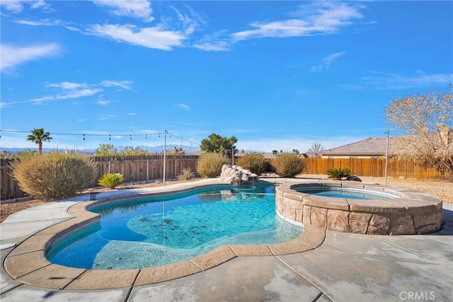 view of swimming pool with an in ground hot tub