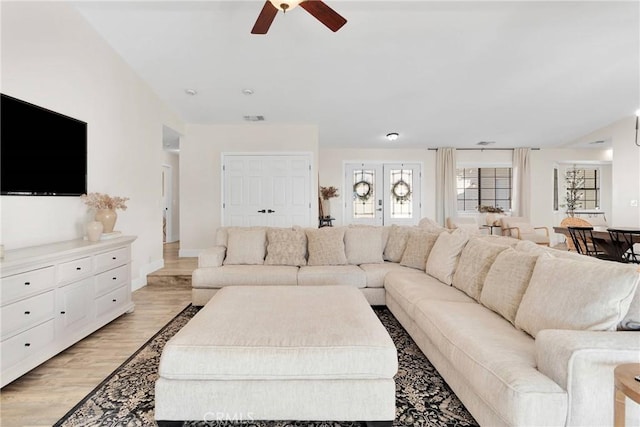 living room with ceiling fan and light hardwood / wood-style floors