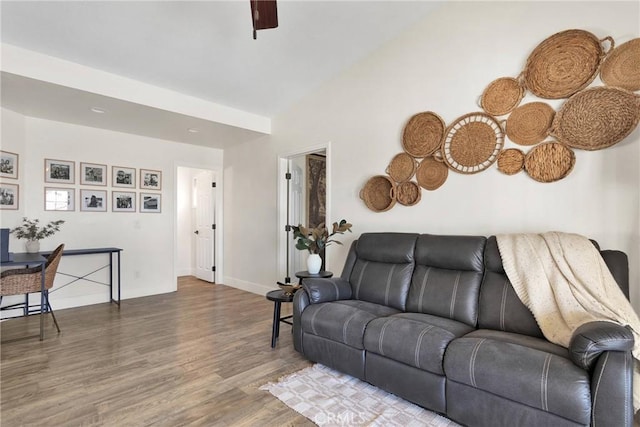 living room featuring lofted ceiling, wood-type flooring, and ceiling fan