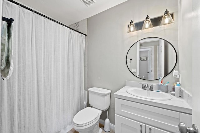 bathroom featuring toilet, a shower with curtain, and vanity