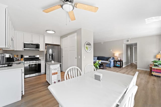 dining area featuring light hardwood / wood-style floors and ceiling fan