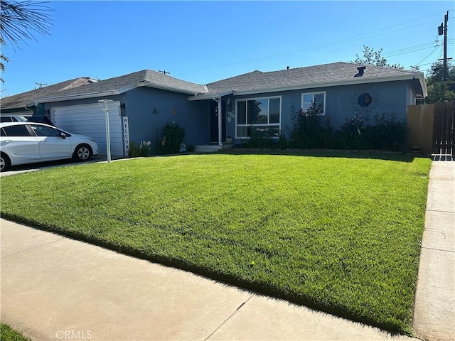 ranch-style house featuring a front lawn and a garage