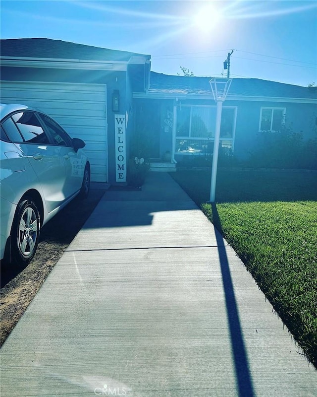 view of front of home with a front yard and a garage