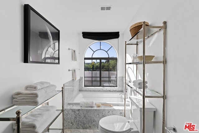 bathroom with tiled bath