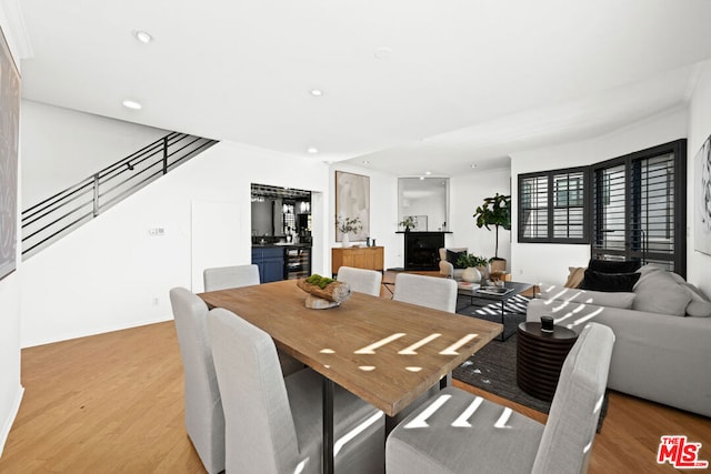 dining room with wine cooler and light hardwood / wood-style flooring