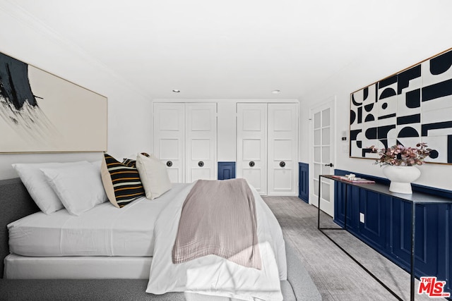 carpeted bedroom featuring ornamental molding