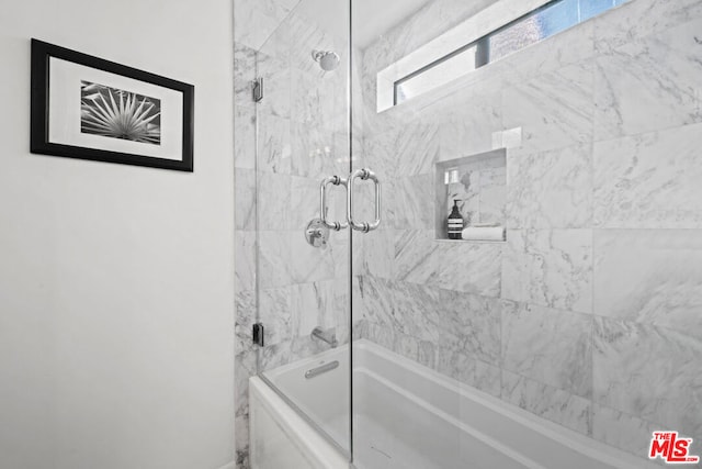 bathroom featuring shower / bath combination with glass door