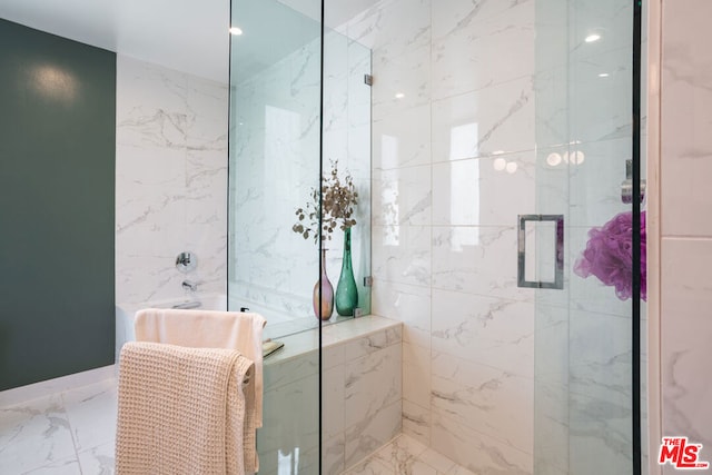 bathroom featuring a shower with door