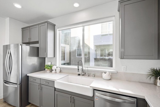 kitchen featuring sink, gray cabinetry, and appliances with stainless steel finishes