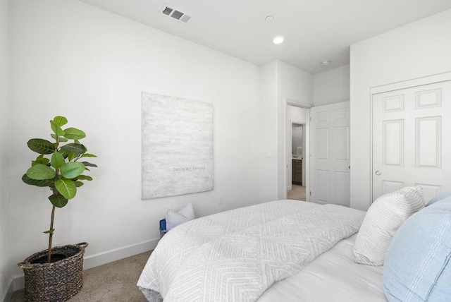 bedroom featuring a closet and light carpet