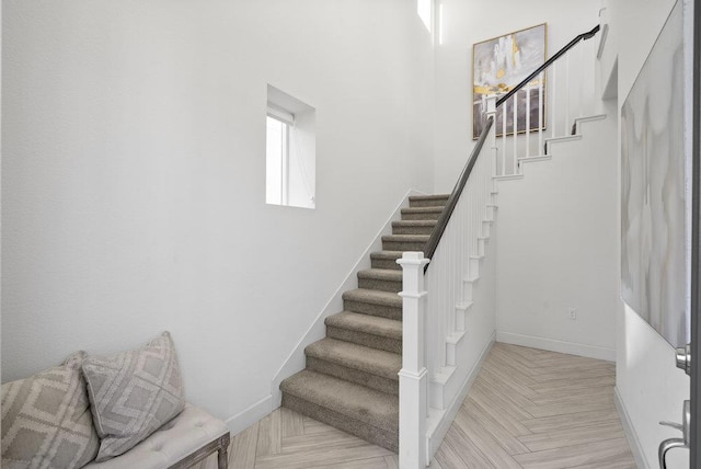 stairs featuring parquet floors