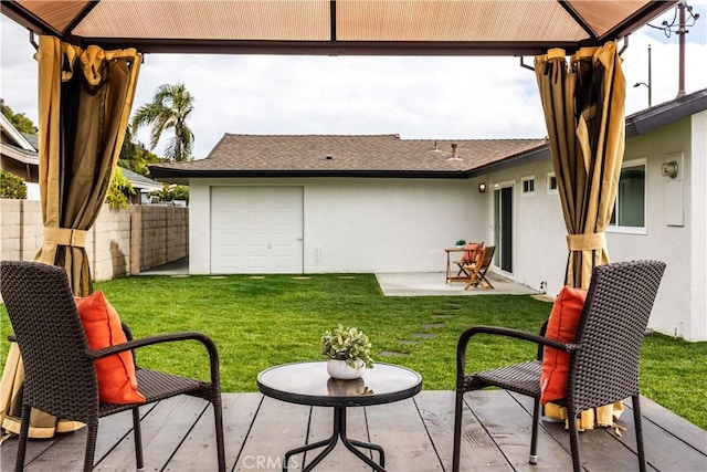 back of house featuring a gazebo, a patio, and a lawn