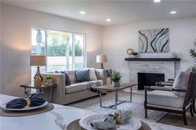 living room with a stone fireplace