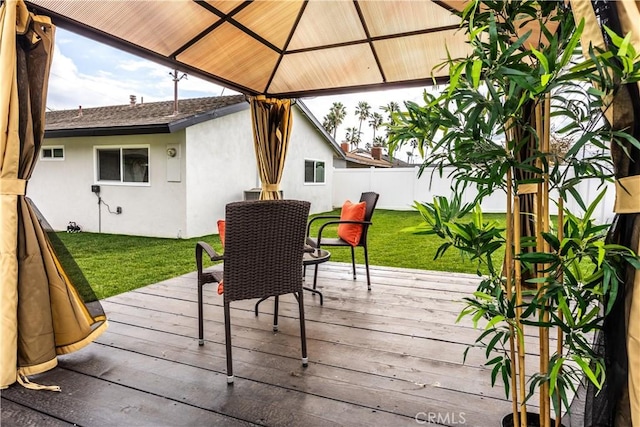 wooden deck with a gazebo and a lawn