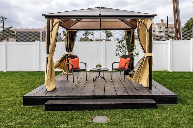 wooden terrace with a gazebo and a yard