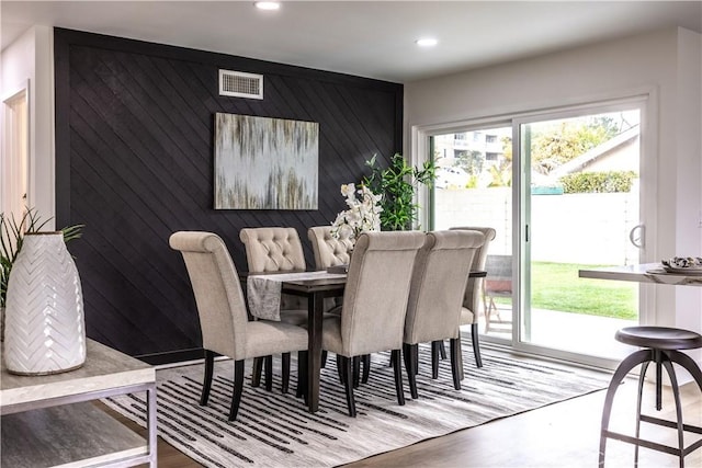 dining room with wooden walls