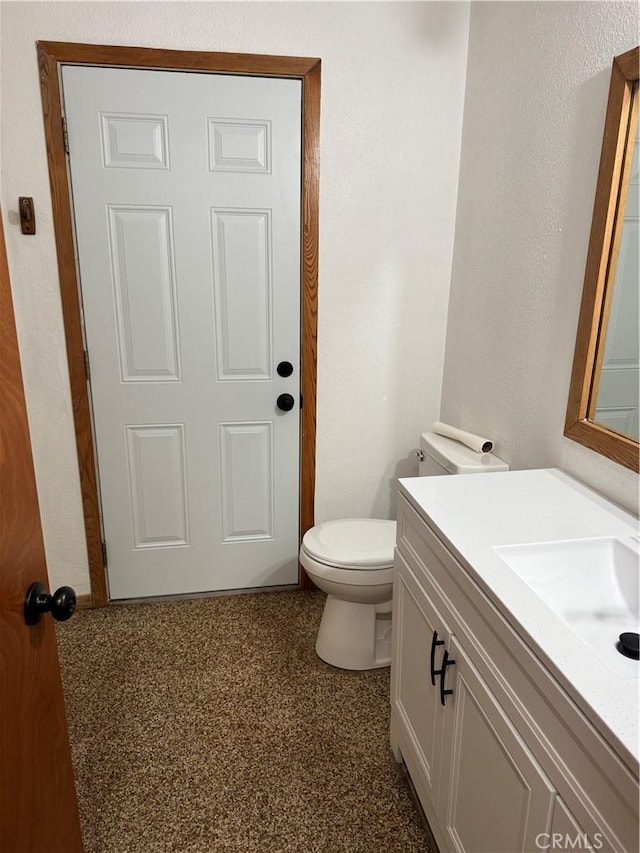 bathroom with toilet and vanity