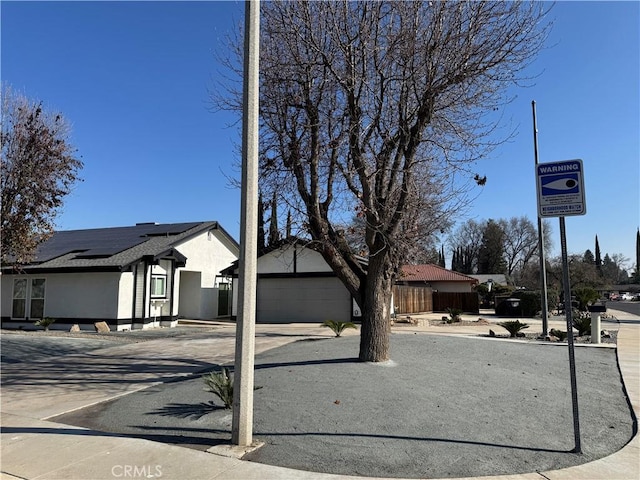 ranch-style house with solar panels