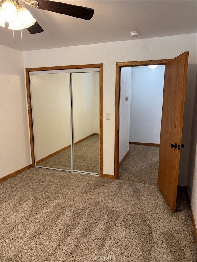 unfurnished bedroom with carpet flooring, a closet, and ceiling fan