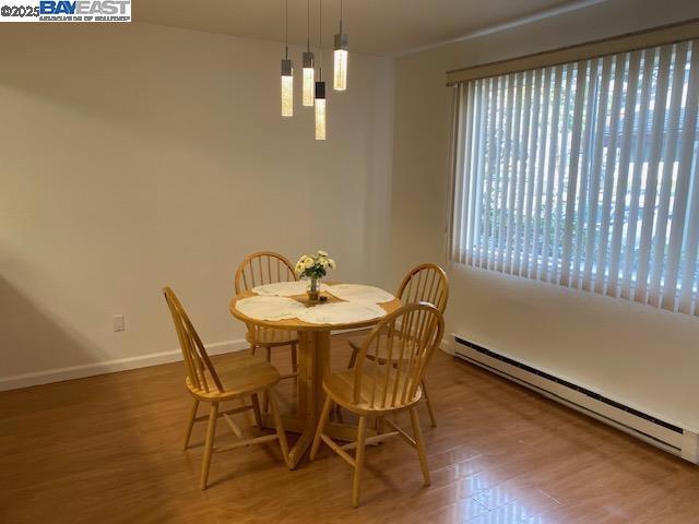 dining space with a baseboard radiator