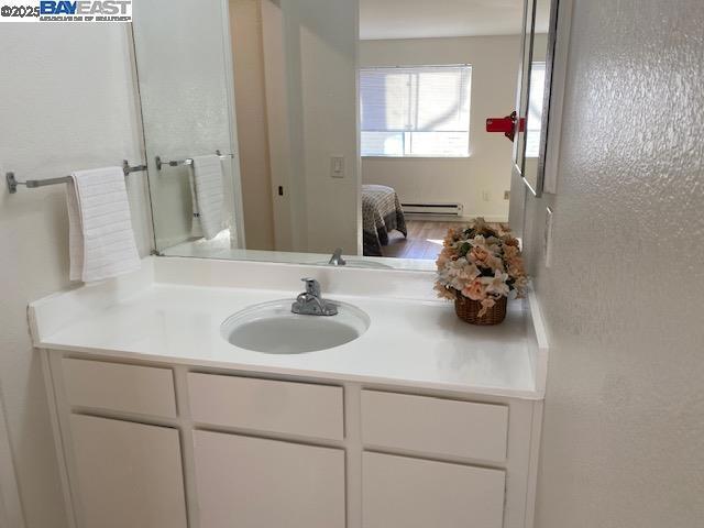 bathroom featuring vanity and a baseboard heating unit