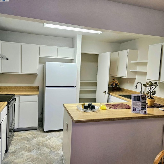 kitchen with sink, white cabinetry, white fridge, stainless steel electric range oven, and wooden counters