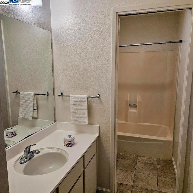 bathroom featuring vanity and shower / tub combination