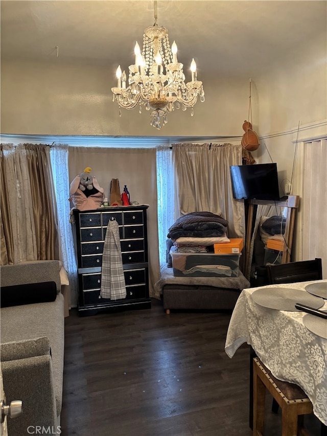 bedroom with dark wood-type flooring and a chandelier